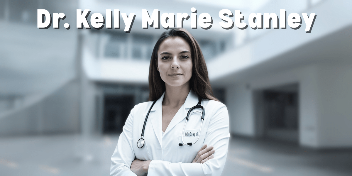 Dr. Kelly Marie Stanley, a confident and professional female doctor, stands with arms crossed in a white coat with a stethoscope around her neck in a modern medical setting.