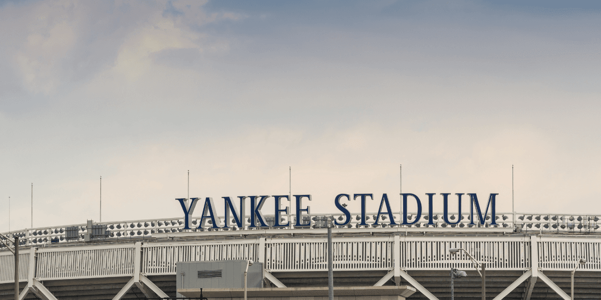 The exterior sign of Yankee Stadium against a cloudy sky