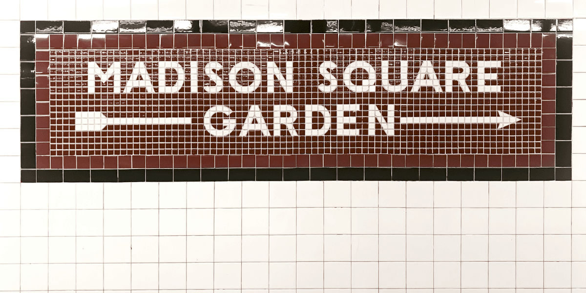 Tile mosaic sign for Madison Square Garden with directional arrows