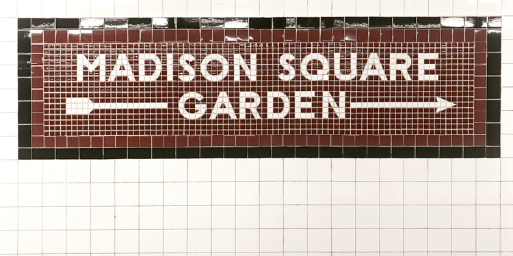 Tile mosaic sign for Madison Square Garden with directional arrows