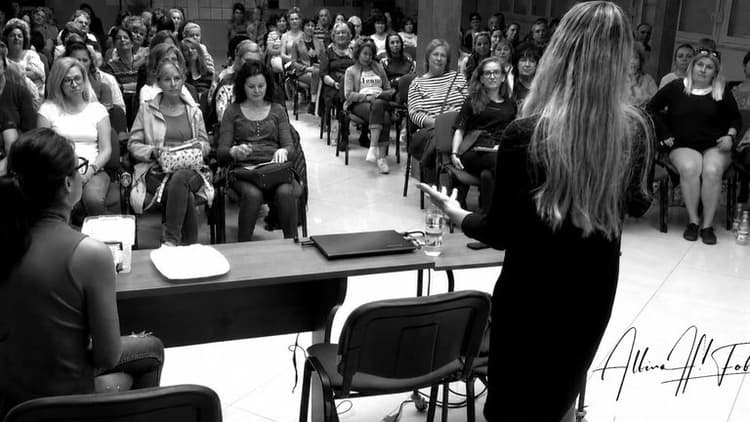Albina Fabiani presenting to a large audience during a medical biophysics educational seminar.