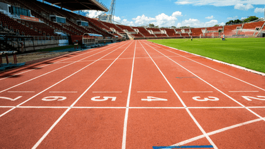 Running track and stadium at Icahn Stadium prepared for track and field competition.