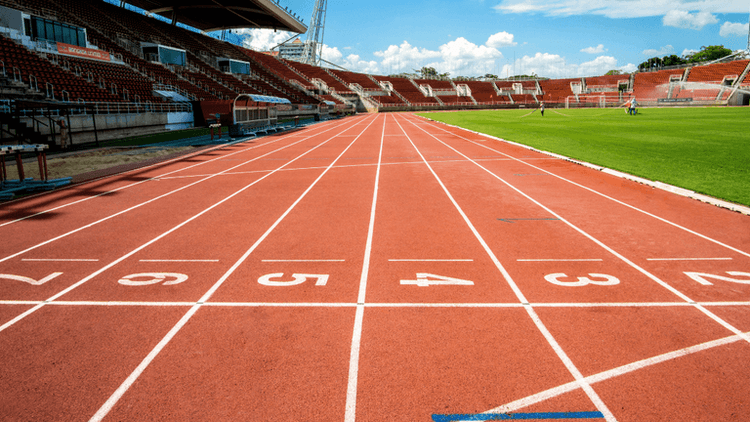 Running track and stadium at Icahn Stadium prepared for track and field competition.