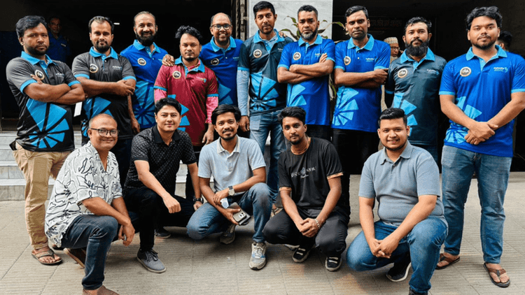 Group photo of a sports team or corporate group, featuring men in branded blue and black uniforms standing and sitting together, showcasing team spirit and camaraderie.