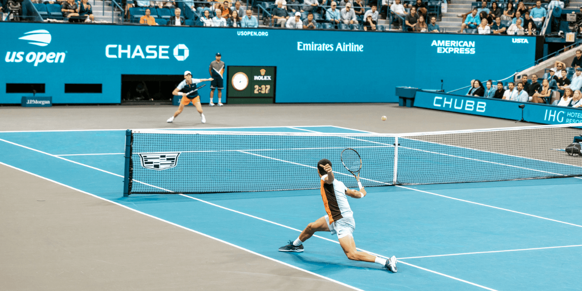 Tennis players competing on a blue court during a match at the US Open