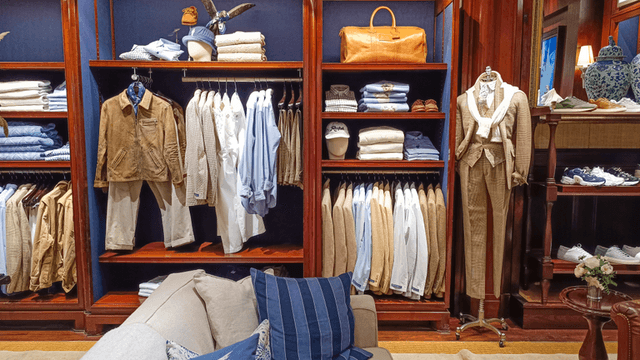 A stylish clothing display featuring neatly arranged shirts, pants, and accessories in a store