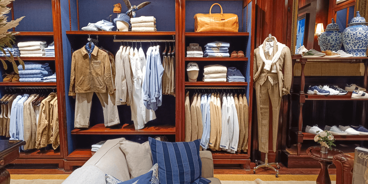 A stylish clothing display featuring neatly arranged shirts, pants, and accessories in a store