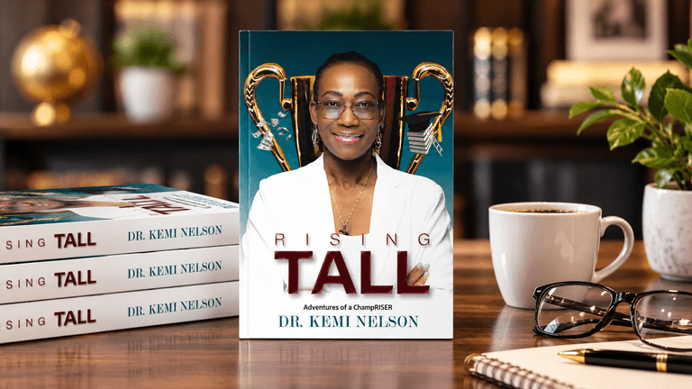 A book titled "Rising Tall" by Dr. Kemi Nelson displayed among coffee and glasses.