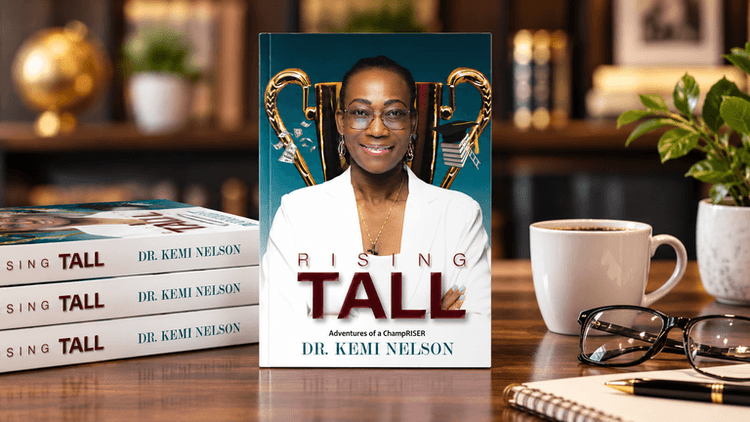 A book titled "Rising Tall" by Dr. Kemi Nelson displayed among coffee and glasses.