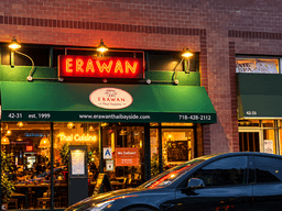 Erawan Thai restaurant exterior with neon sign and green awning at dusk