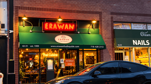 Erawan Thai restaurant exterior with neon sign and green awning at dusk
