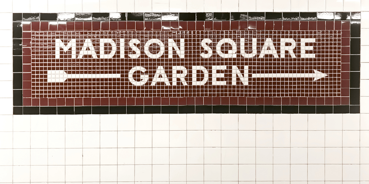 Tile mosaic sign for Madison Square Garden with directional arrows