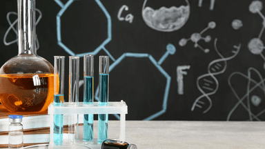 Laboratory setup with test tubes, a flask, and a chalkboard with chemical diagrams