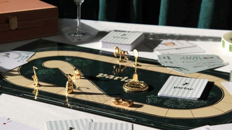 A table set with a game board, cards, and a glass of wine, inviting social interaction and engaging gameplay.