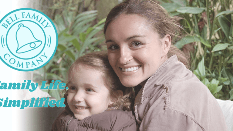 Mother and daughter smiling together in a lush garden, representing family life support provided by Bell Family Company.