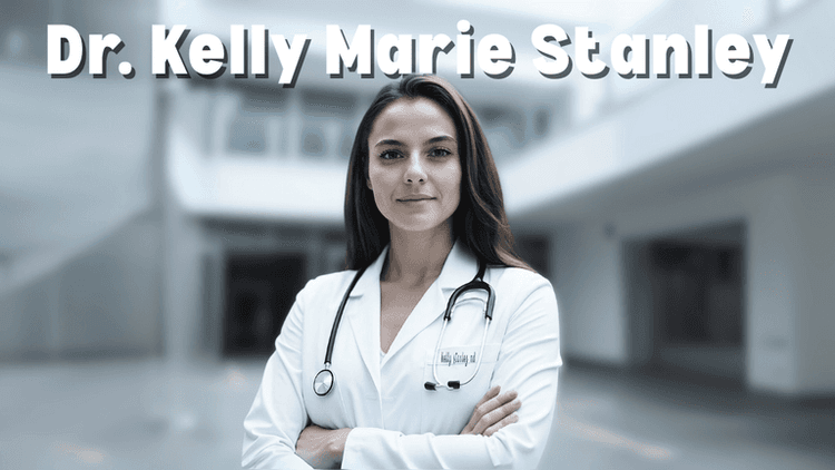 Dr. Kelly Marie Stanley, a confident and professional female doctor, stands with arms crossed in a white coat with a stethoscope around her neck in a modern medical setting.