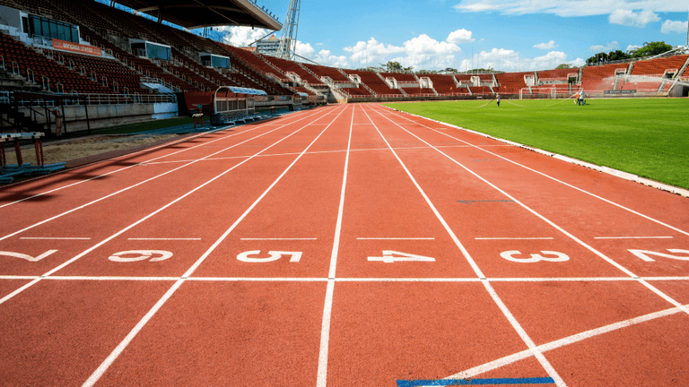 Running track and stadium at Icahn Stadium prepared for track and field competition.