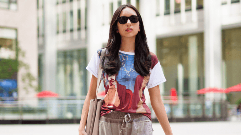 A person wearing a Storyteller’s Closet art-driven T-shirt, embodying narrative fashion in a cityscape.