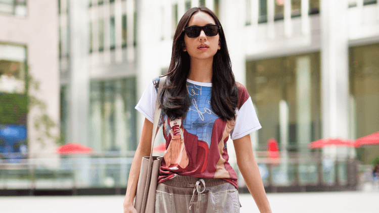 A person wearing a Storyteller’s Closet art-driven T-shirt, embodying narrative fashion in a cityscape.