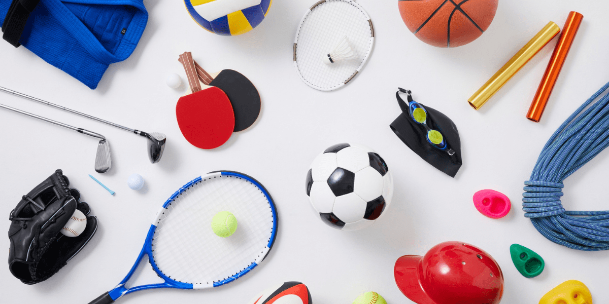 Assorted sports equipment including soccer ball, tennis racket, basketball, baseball glove, and swimming goggles on a white background.