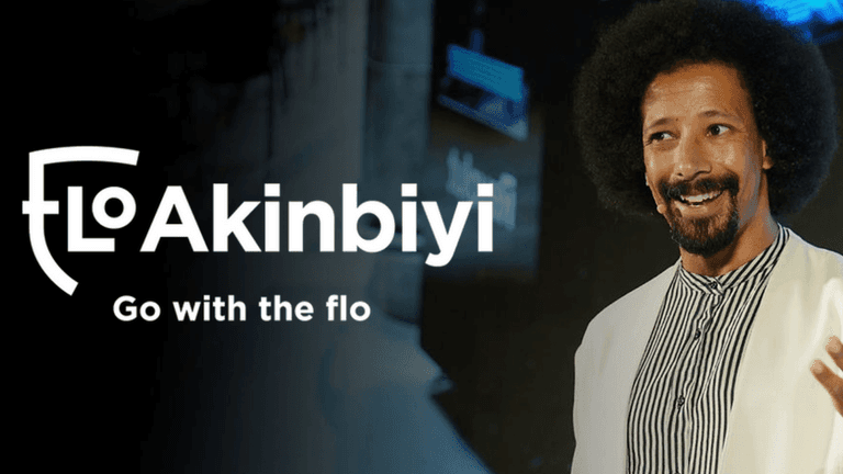 Flo Akinbiyi, dynamic communication coach, speaking at an event, empowering leaders to communicate confidently and effectively.