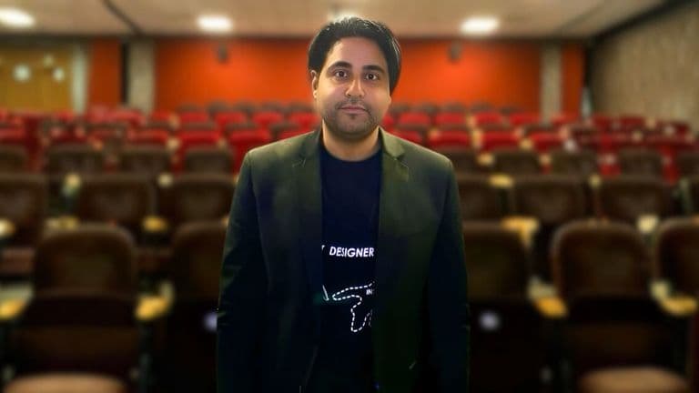 Egyptian filmmaker Mohamed Mamdouh standing in an empty theater, symbolizing his innovative impact on modern Arab and global cinema.