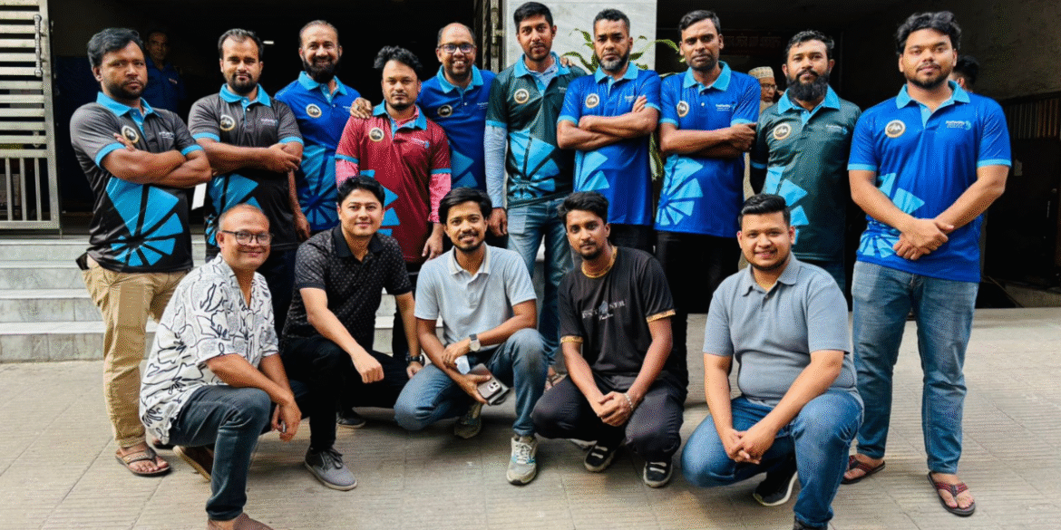 Group photo of a sports team or corporate group, featuring men in branded blue and black uniforms standing and sitting together, showcasing team spirit and camaraderie.