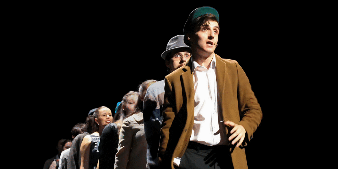 Actor leads cast in dramatic scene from Irish musical Most Peculiar Dreams on stage.